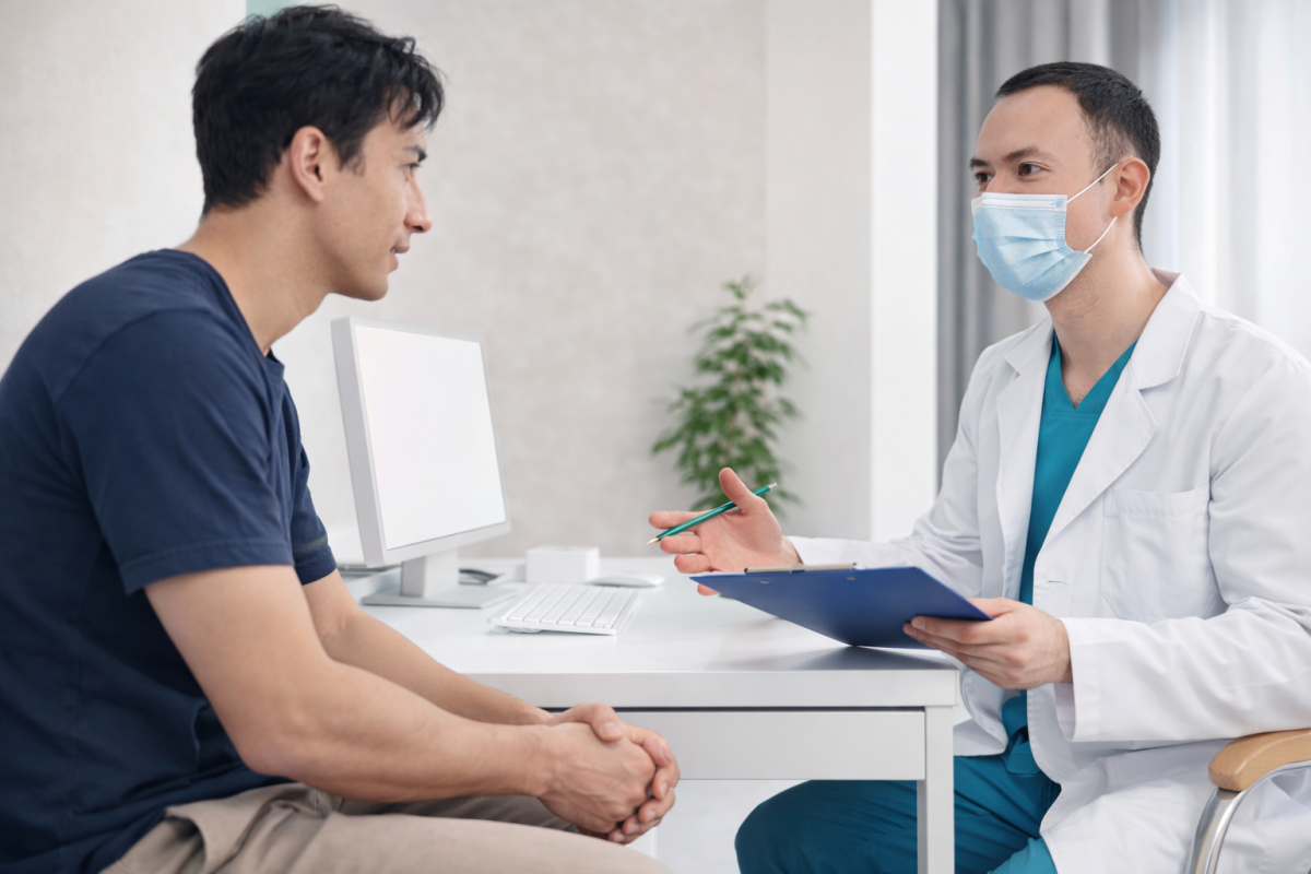 Male patient consulting a doctor about abnormal penile discharge and STD symptoms