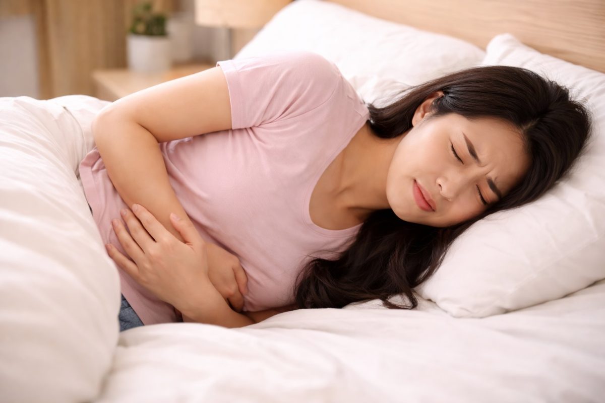 Seorang wanita berasa sakit tidur di atas katil