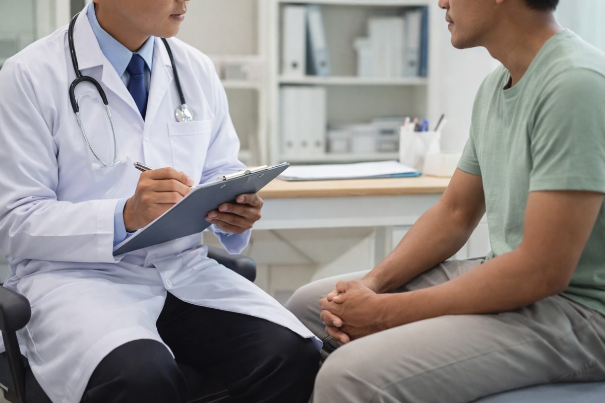 a doctor advising a male patient during a consultation