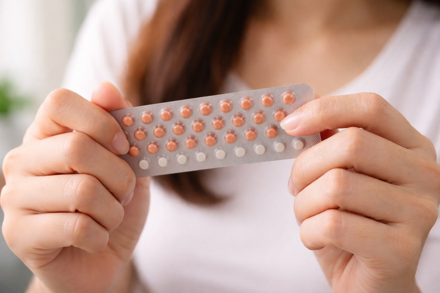 Woman holding birth control pills, illustrating contraception use and lack of STD protection