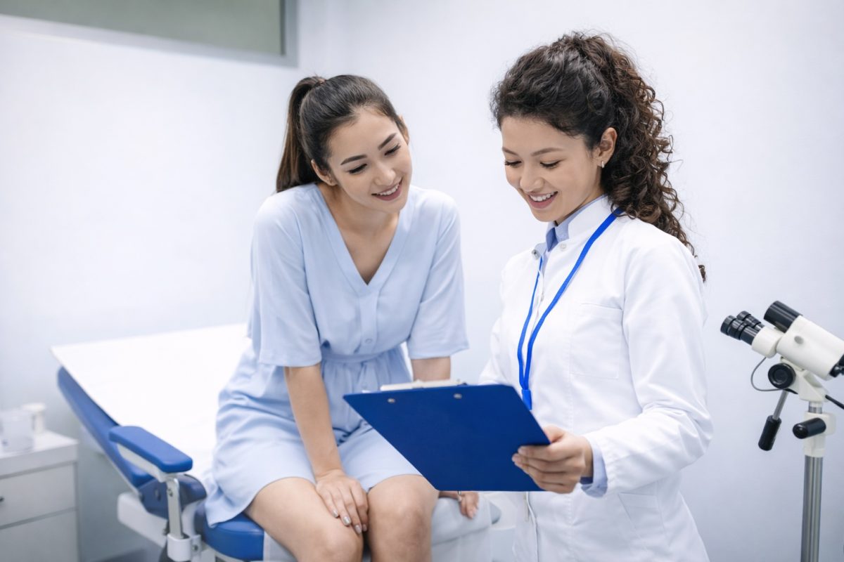 Female doctor consulting patient in clinic, discussing genital hygiene, reproductive health, and preventive care