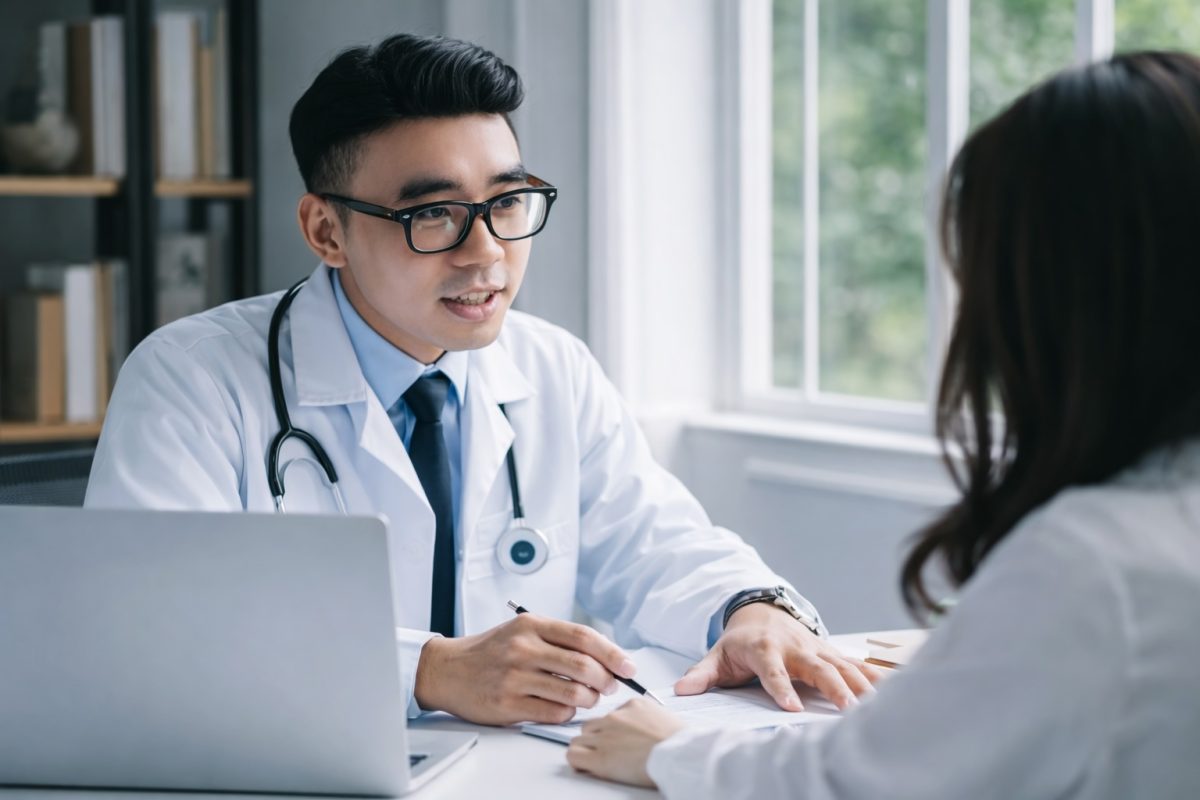 Doctor consulting patient in clinic, discussing STD prevention, testing, and sexual health advice