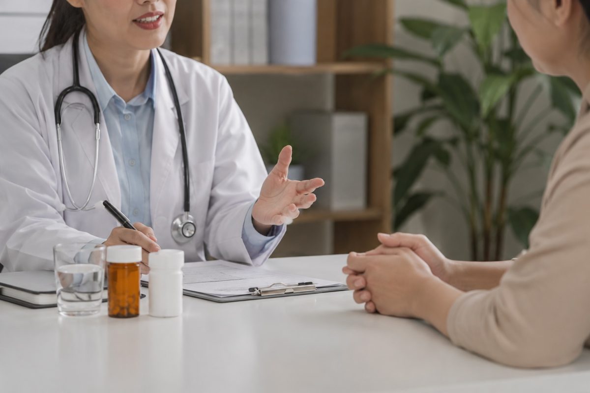 Doctor discussing chronic std treatment and long-term infection management during a confidential medical consultation.