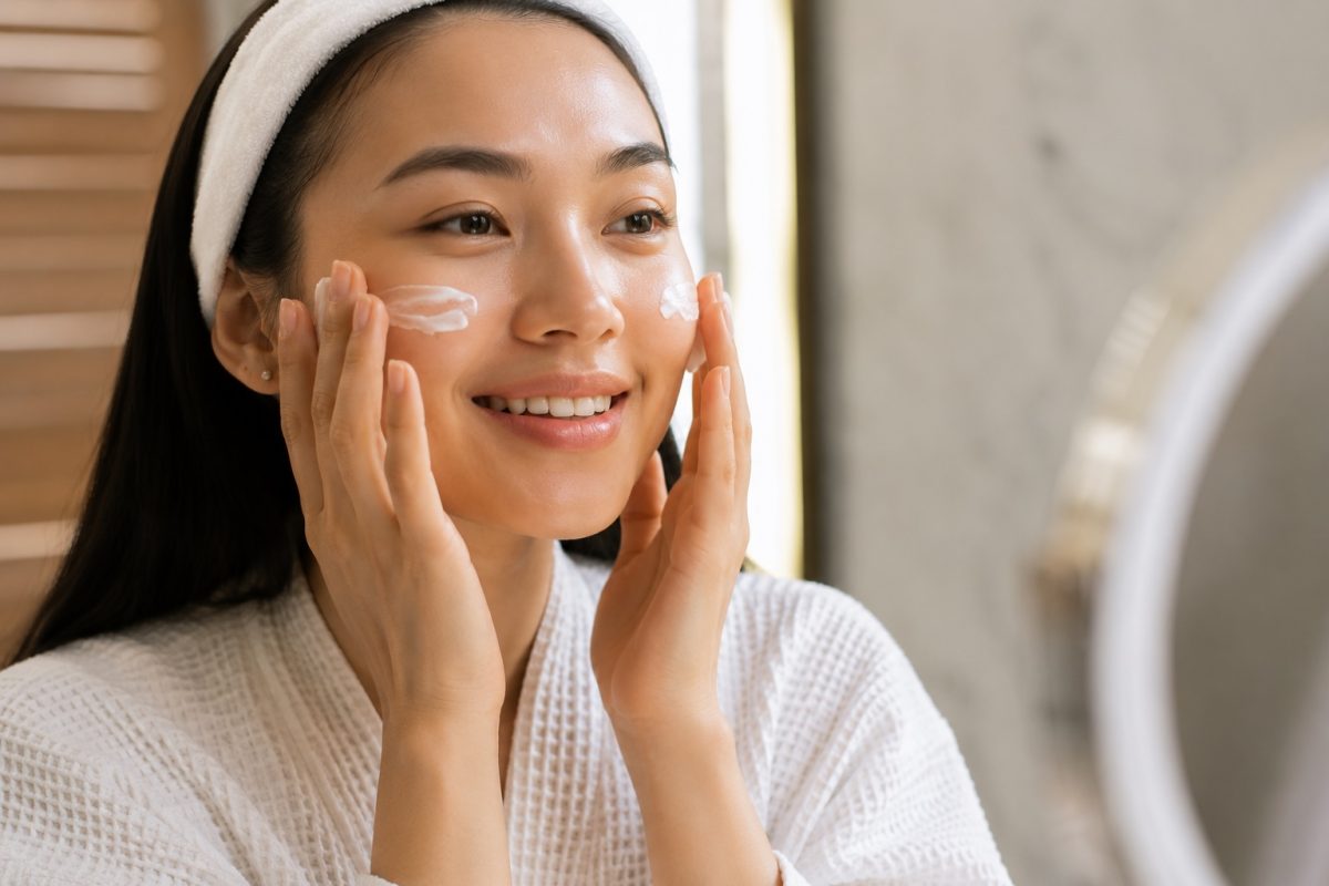 Woman applying skincare to support hydration and improve dry skin