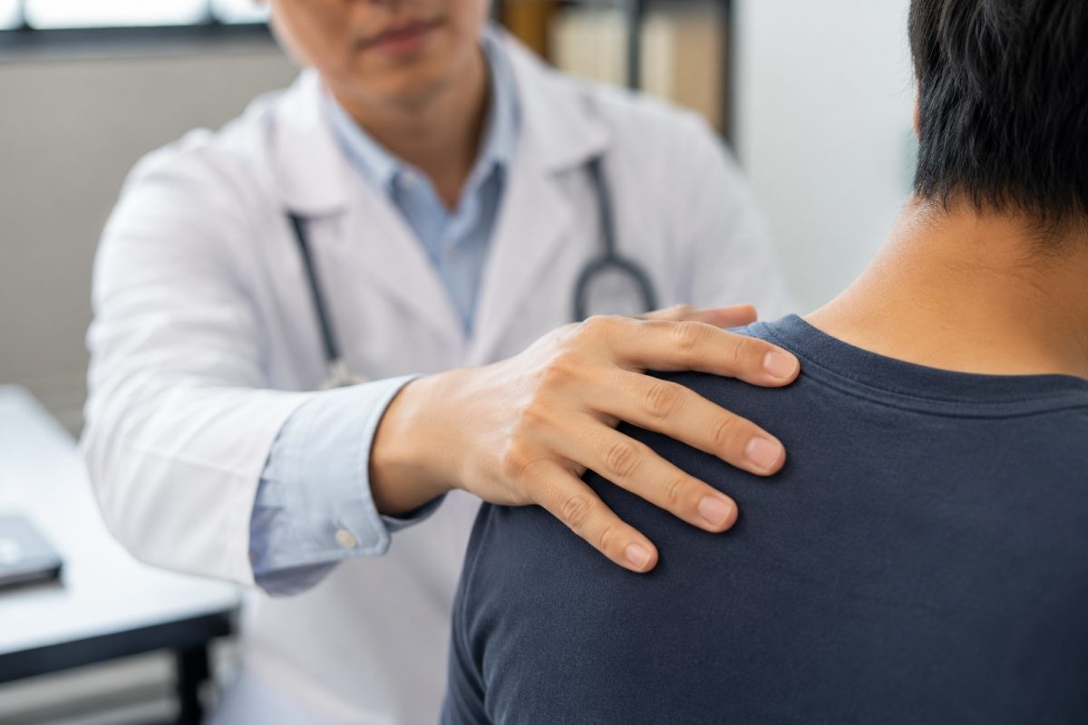Doctor examining swollen lymph node or neck area during consultation for possible infection symptoms